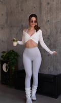 White twist-front cropped long-sleeve top styled with light leggings