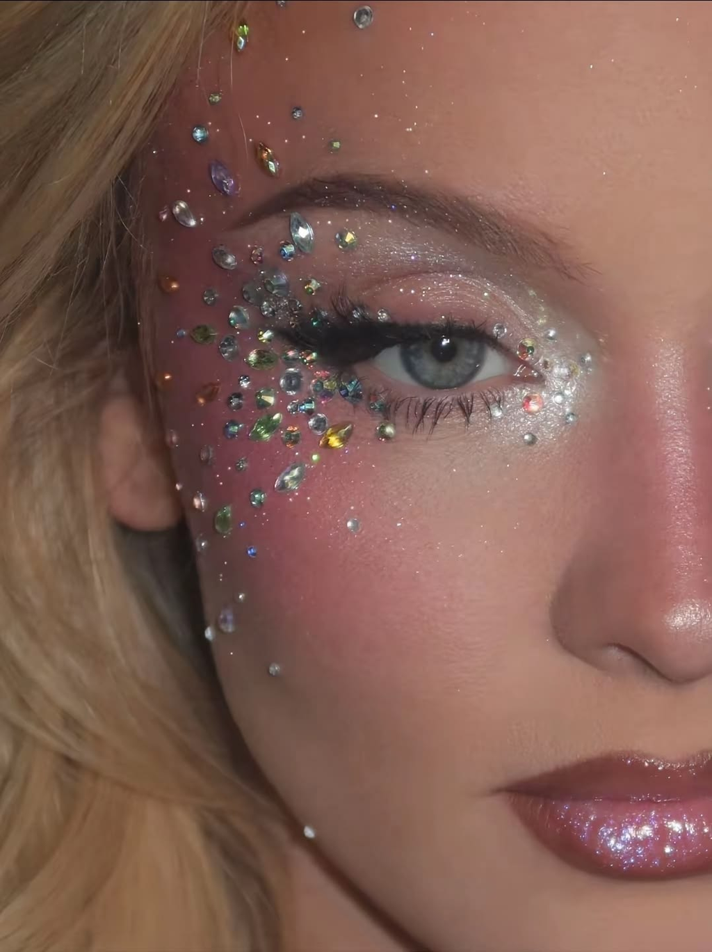 Silver and colorful rhinestones arranged around an eye